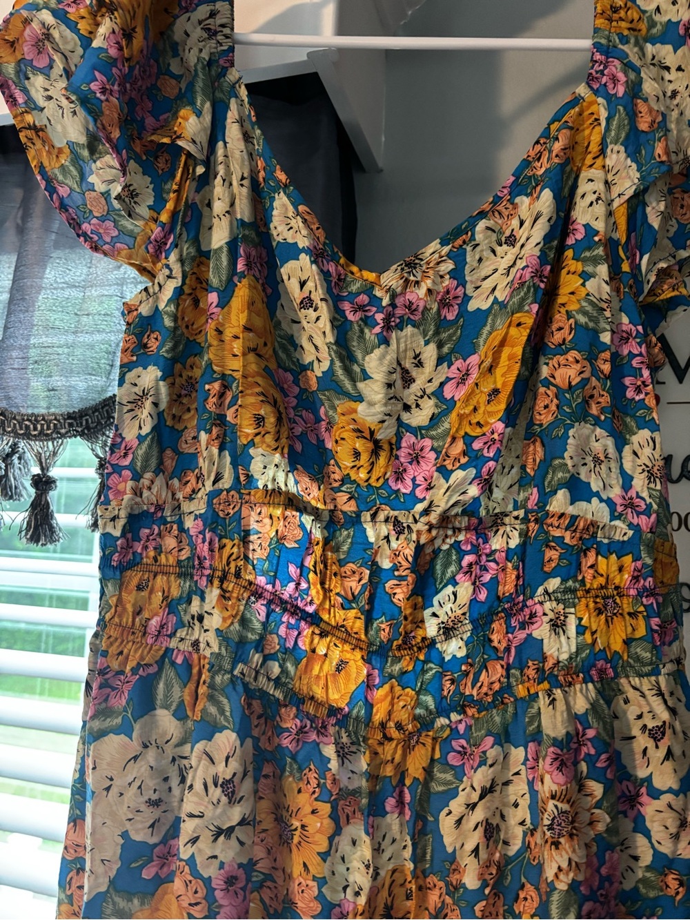 Floral jumper with elastic bust and ruffle sleeves and hem.